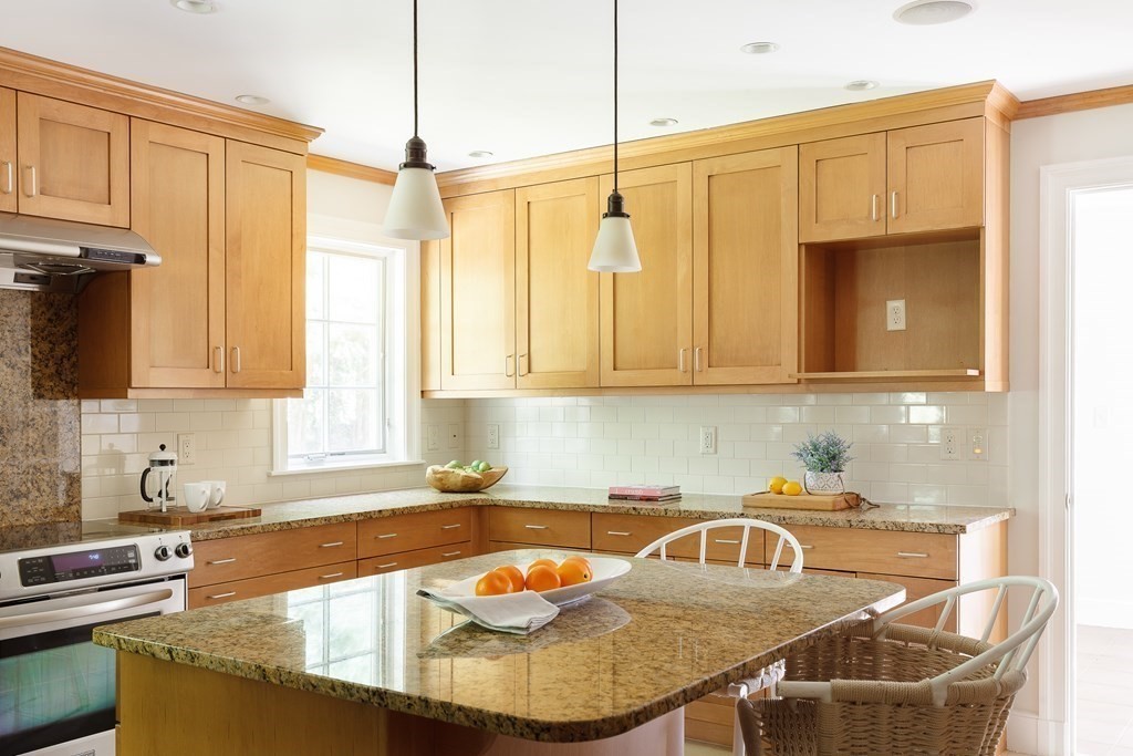 150 Fletcher Road Belmont, MA 02478 - Photo 8 of 33 a kitchen with stainless steel appliances granite countertop a sink a stove and a wooden cabinets