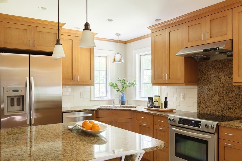 150 Fletcher Road Belmont, MA 02478 - Photo 9 of 33 a kitchen with stainless steel appliances granite countertop a sink a stove and a refrigerator