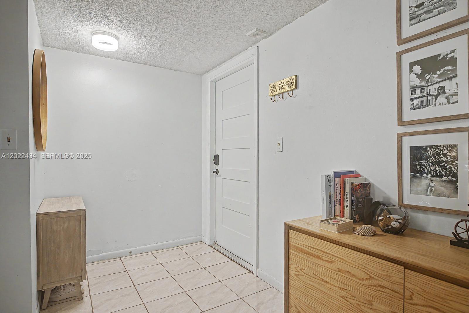 13045 Southwest 68th Street, Unit 111 Miami, FL 33183 - Photo 2 of 15 a bathroom with a granite countertop sink a toilet and mirror
