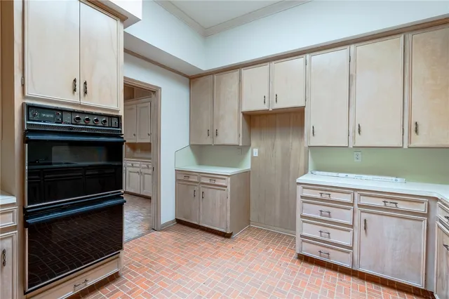 a kitchen with granite countertop white cabinets and stainless steel appliances