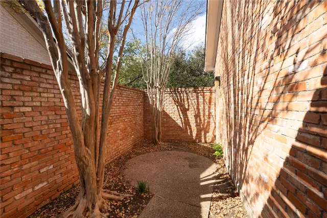 a view of a porch with a table and chairs and potted plants