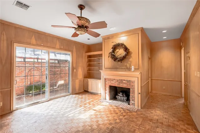 a view of a livingroom with a fireplace and fan
