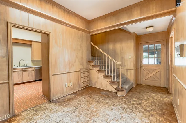 a view of a hallway with a white walls and stairs