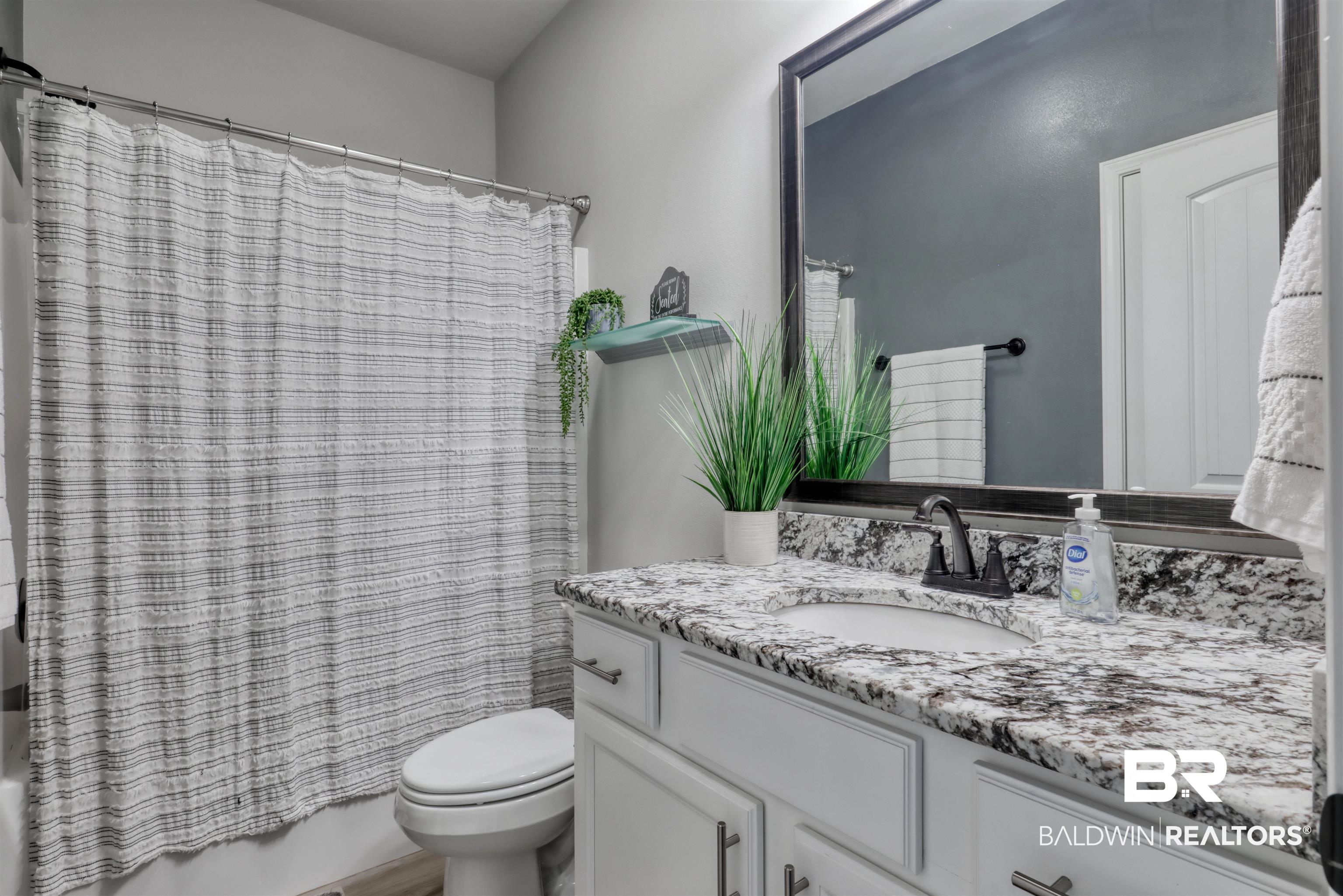 987 Gibson Court Foley, AL 36535 - Photo 23 of 34 Full bathroom featuring vanity, shower / bath combo, and toilet