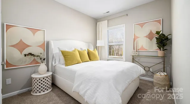 a bedroom with a bed and a painting on the wall