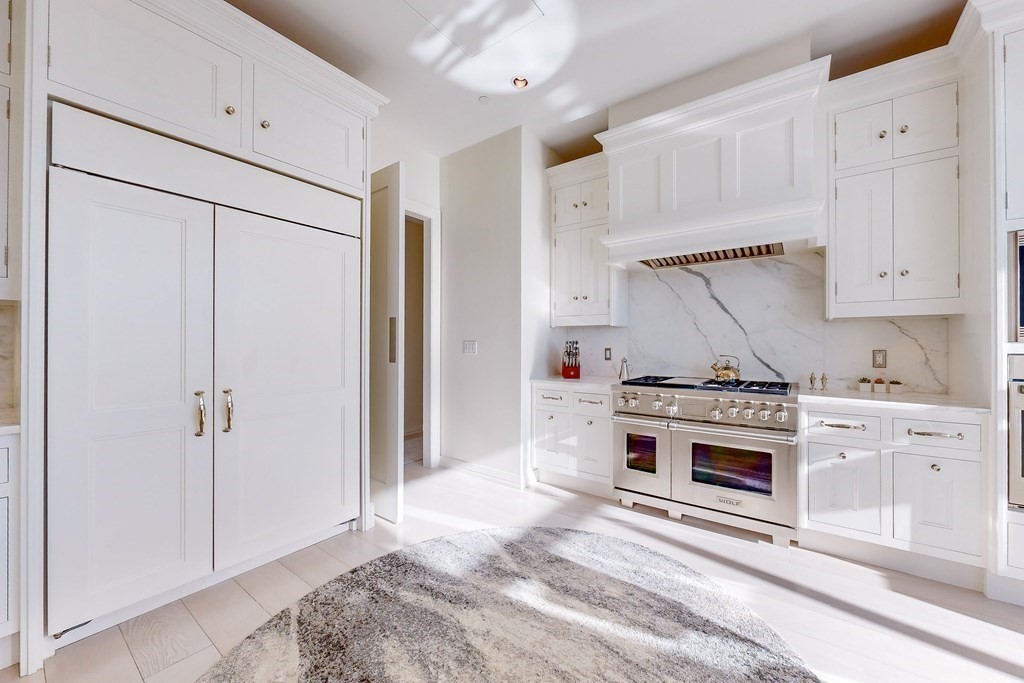 1 Franklin Street, Unit PH4E Boston, MA 02110 - Photo 14 of 40 a kitchen with stainless steel appliances white cabinets and white appliances