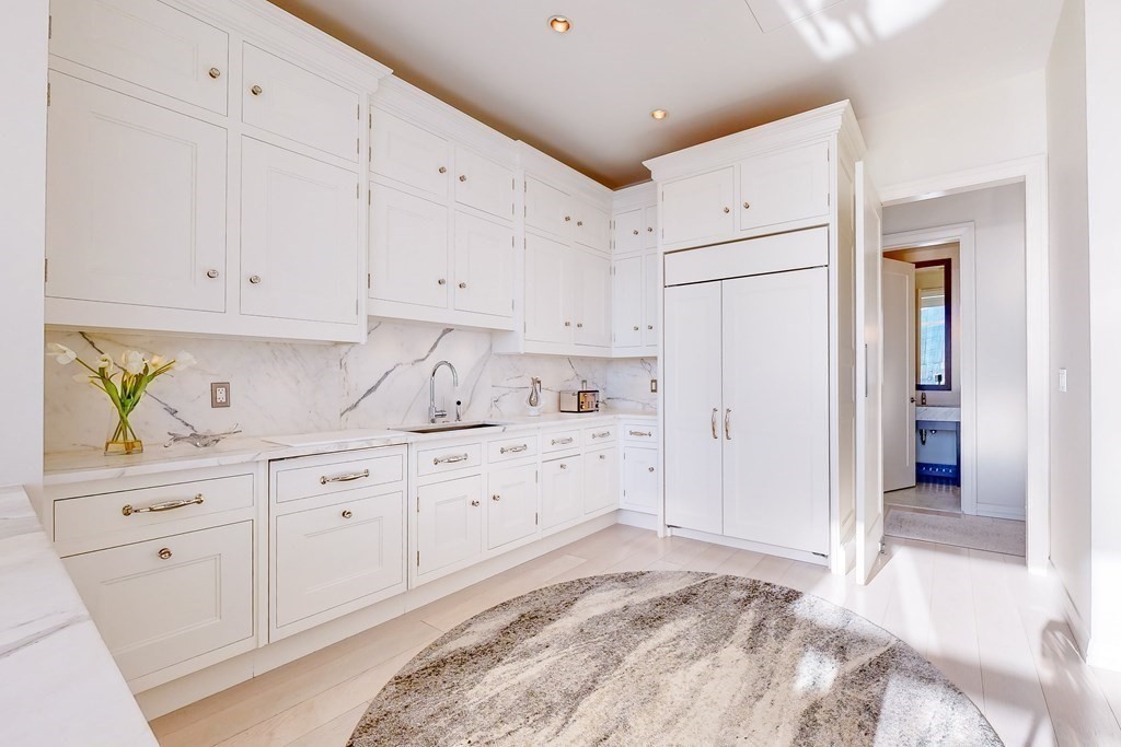 1 Franklin Street, Unit PH4E Boston, MA 02110 - Photo 15 of 40 a kitchen with white cabinets and white appliances
