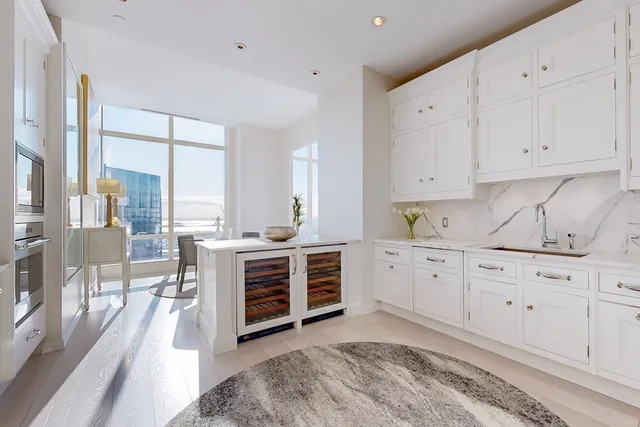 a kitchen with cabinets appliances and a large window