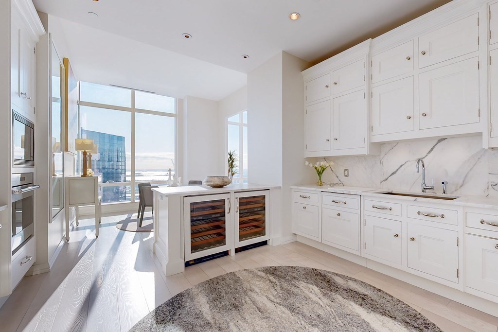 1 Franklin Street, Unit PH4E Boston, MA 02110 - Photo 17 of 40 a kitchen with cabinets appliances and a large window