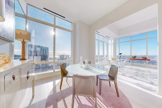 a view of a a dining room with furniture window and wooden floor