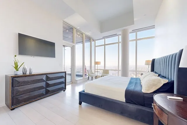 a bedroom with a bed and flat screen tv