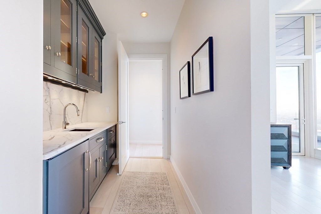 1 Franklin Street, Unit PH4E Boston, MA 02110 - Photo 23 of 40 a hallway with sink and cabinets