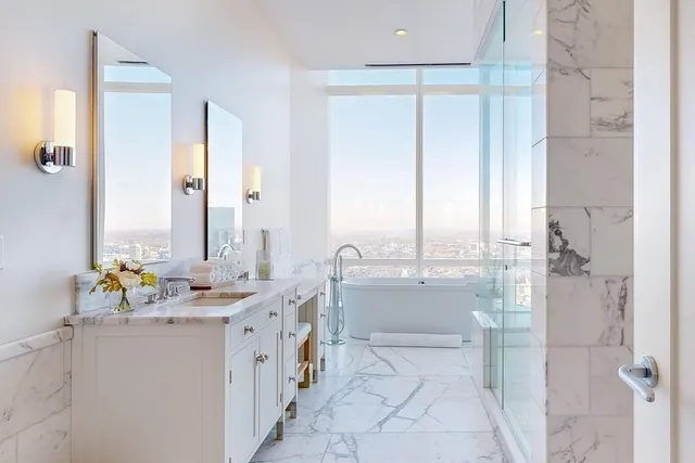 a bathroom with a mirror sink and tub