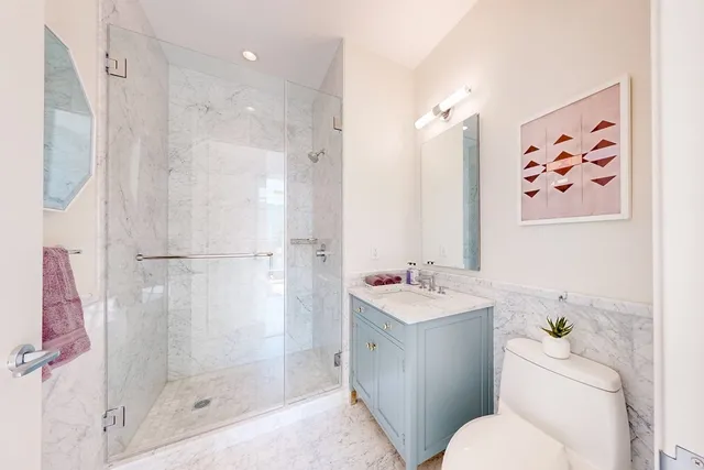 a bathroom with a sink toilet and shower