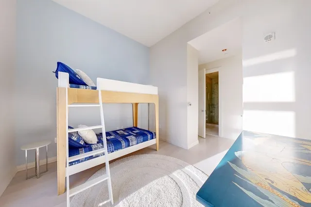 a bed room with a bed and a window