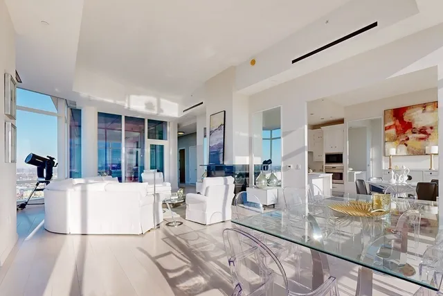 a living room with furniture a flat screen tv and a large window