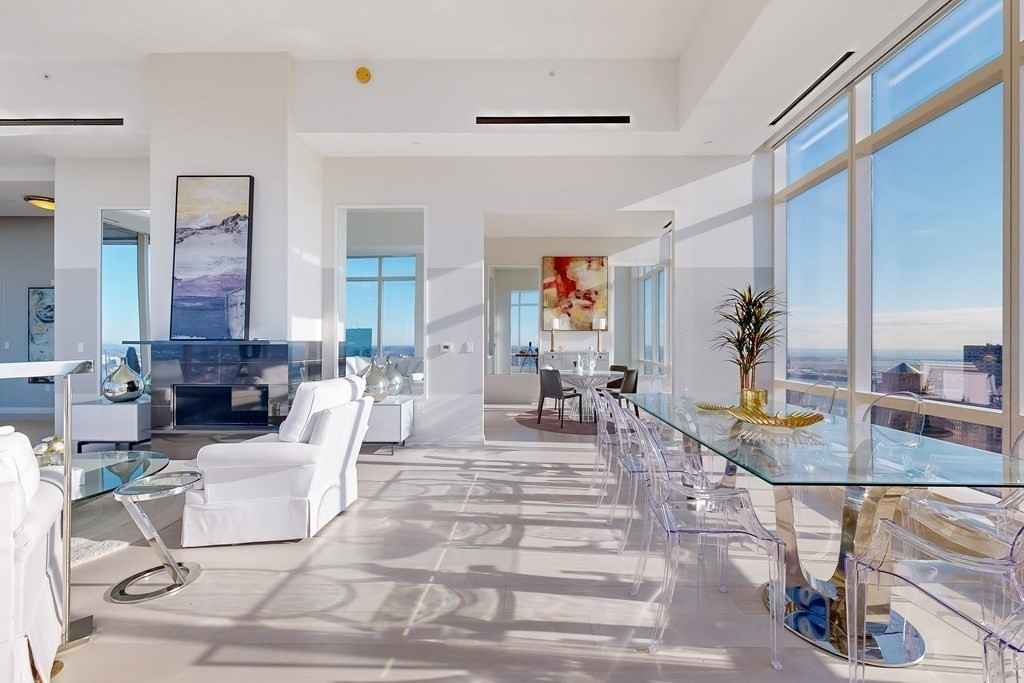 1 Franklin Street, Unit PH4E Boston, MA 02110 - Photo 6 of 40 a living room with fireplace furniture and a potted plant