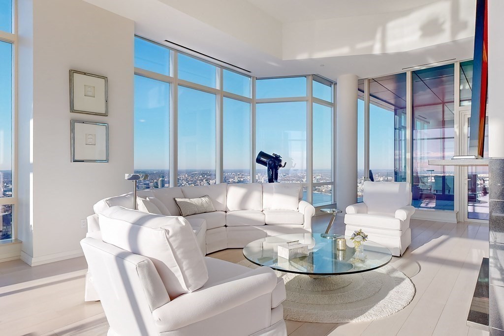 1 Franklin Street, Unit PH4E Boston, MA 02110 - Photo 10 of 40 a dining room with couches a glass table and chairs