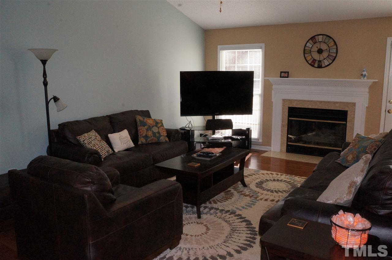 5121 Fairmead Circle Raleigh, NC 27613 - Photo 13 of 21 a living room with furniture a flat screen tv and a fireplace