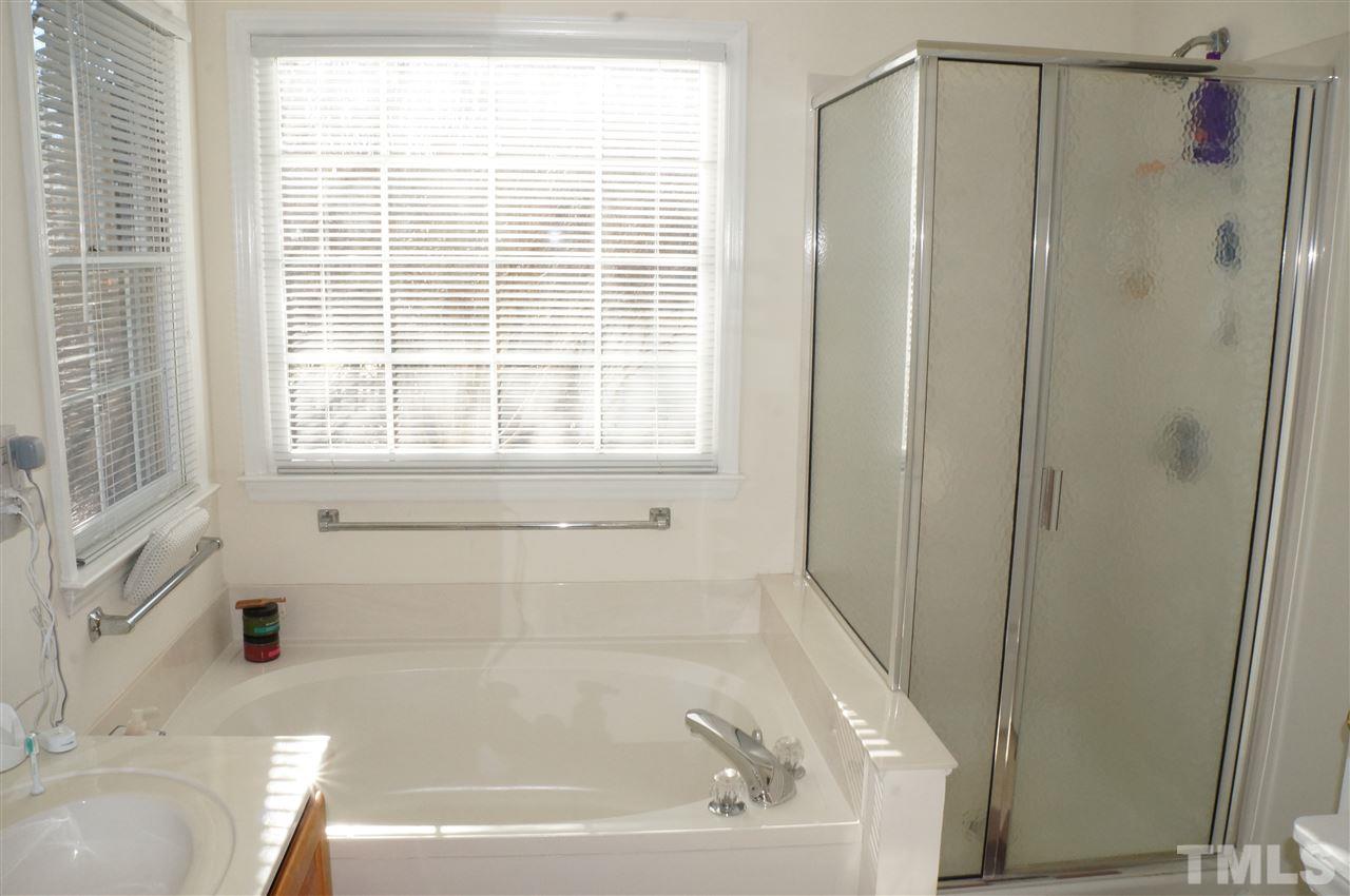 5121 Fairmead Circle Raleigh, NC 27613 - Photo 18 of 21 a bathroom with a bathtub and a shower
