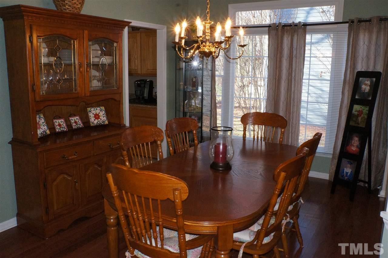 5121 Fairmead Circle Raleigh, NC 27613 - Photo 8 of 21 a view of a dining room with furniture and chandelier