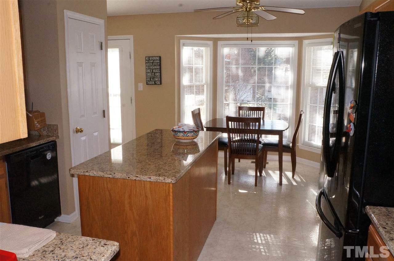 5121 Fairmead Circle Raleigh, NC 27613 - Photo 9 of 21 a dining room with furniture and a floor to ceiling window