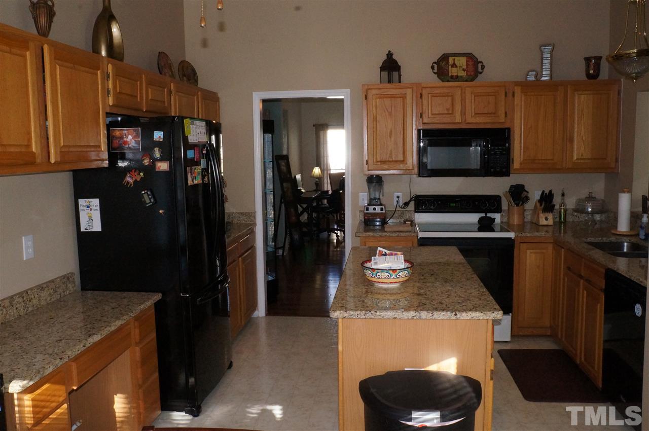 5121 Fairmead Circle Raleigh, NC 27613 - Photo 10 of 21 a kitchen with granite countertop a refrigerator stove and sink