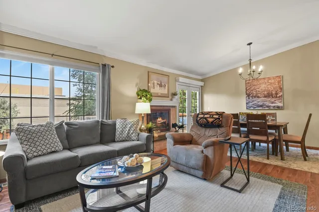 a living room with furniture a dining table and a fireplace