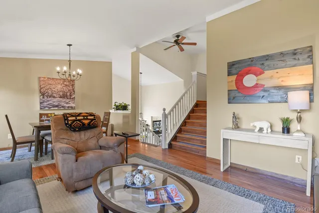 a living room with furniture and a chandelier