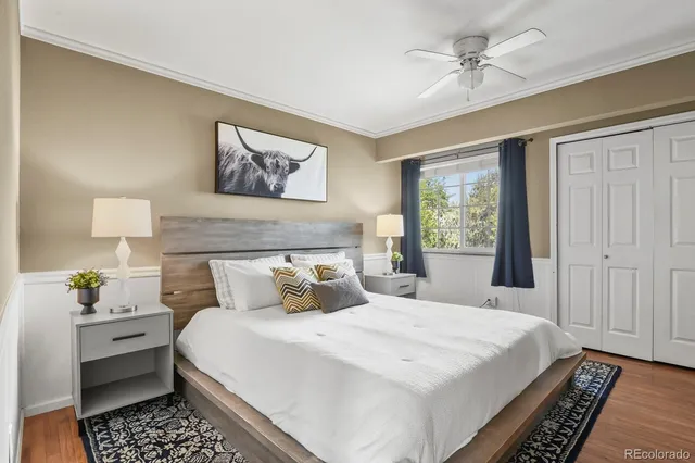 a bedroom with a large bed and a chandelier