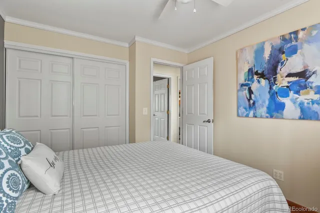a bedroom with a bed and painting on the wall
