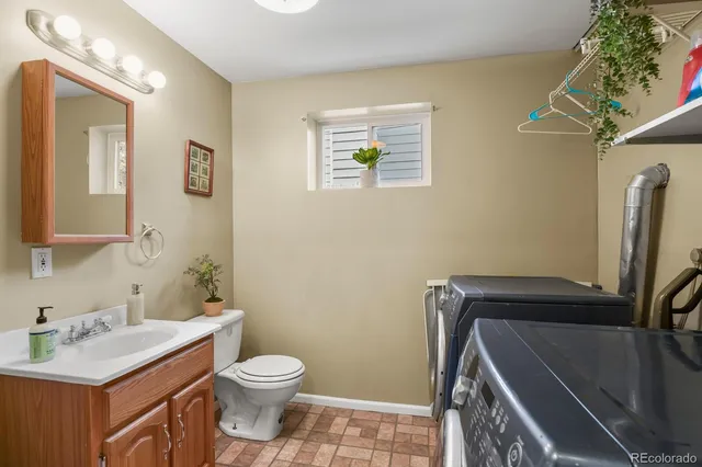 a bathroom with a sink a toilet and mirror