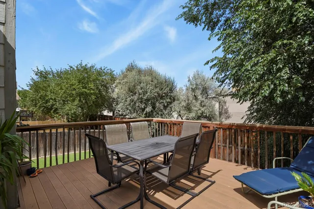 a view of a table and chairs on the roof deck