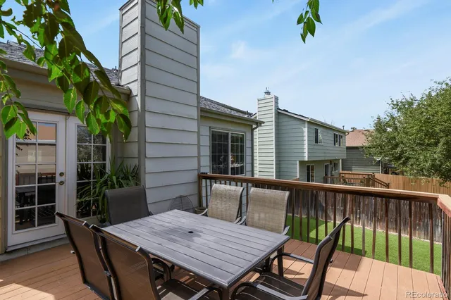 a view of a wooden chairs and table in patio
