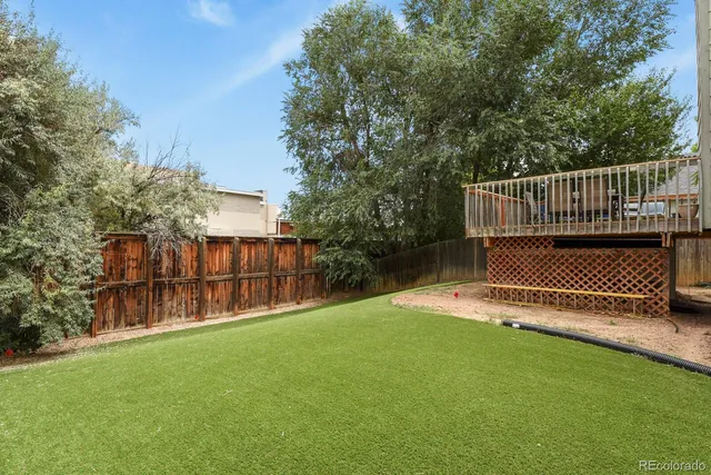 a view of a deck with a chair and grass