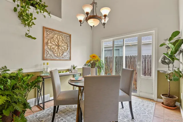 a view of a dining room with furniture wooden floor and chandelier