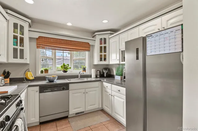 a kitchen with a sink stove and refrigerator