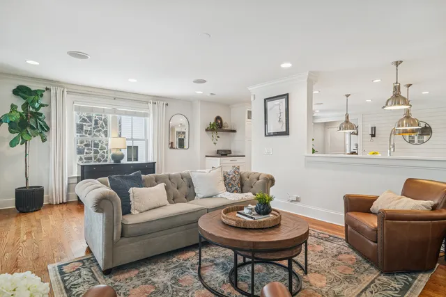 a dining room with furniture a rug and wooden floor