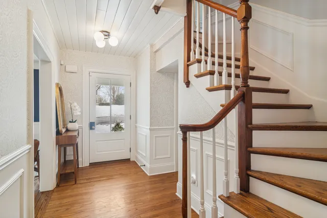 a view of entryway with wooden floor and stairs