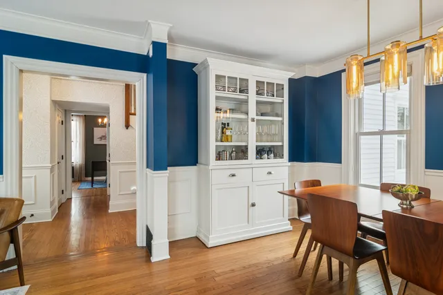a living room with furniture a rug and a flat screen tv