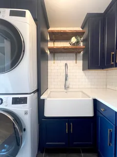 a utility room with sink dryer and washer