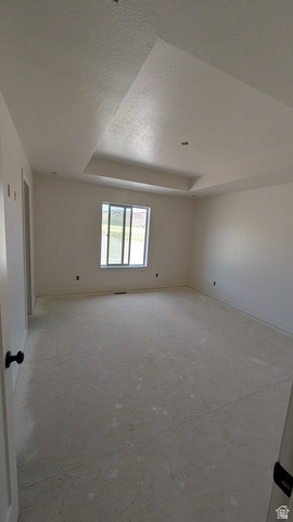 26063 North 8800th West Portage, UT 84331 - Photo 4 of 9 Spacious room featuring a tray ceiling, recessed lighting, and a double-pane window