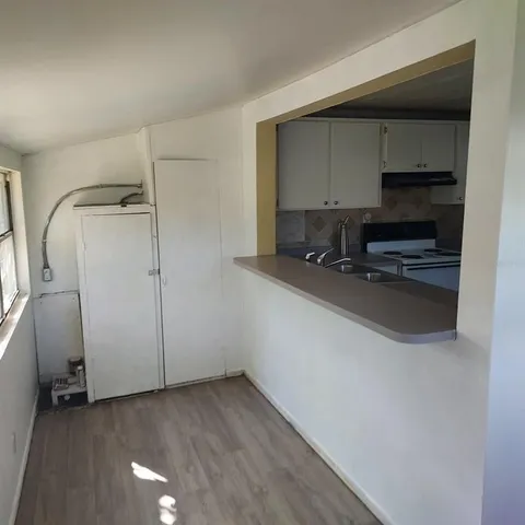 a kitchen with a refrigerator and a sink