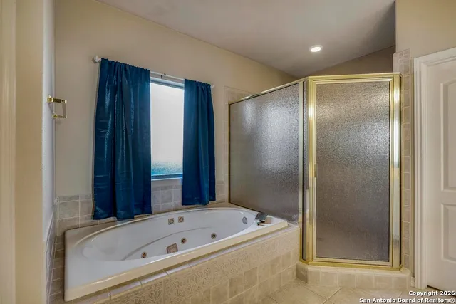 a bathroom with a bathtub and a shower