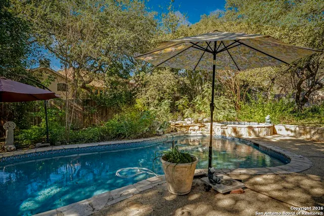 a view of a chair and table under an umbrella