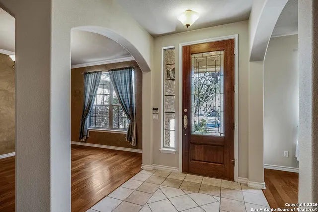 a view of a hallway with wooden floor and a living room