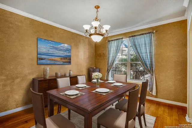 a view of a dining room with furniture wooden floor and chandelier