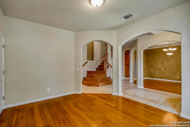 a view of a room with wooden floor and white walls