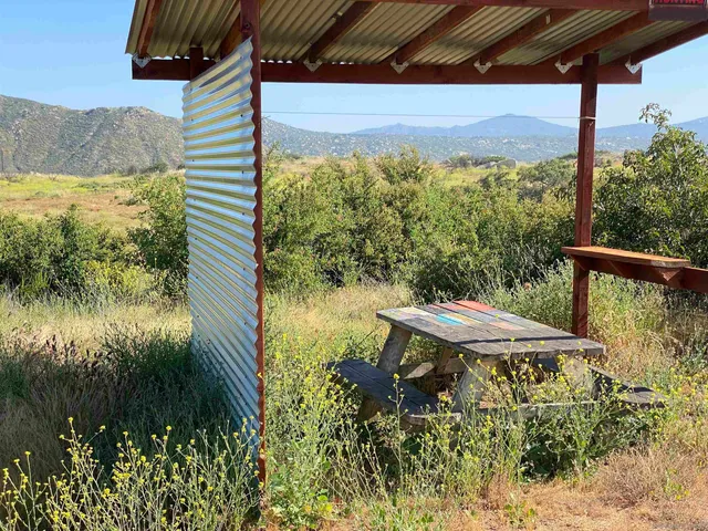 a view of a porch with furniture and a yard