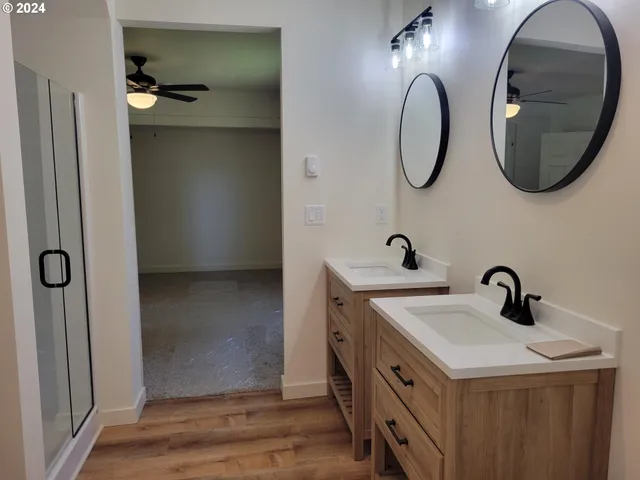 a bathroom with a double vanity sink and a mirror